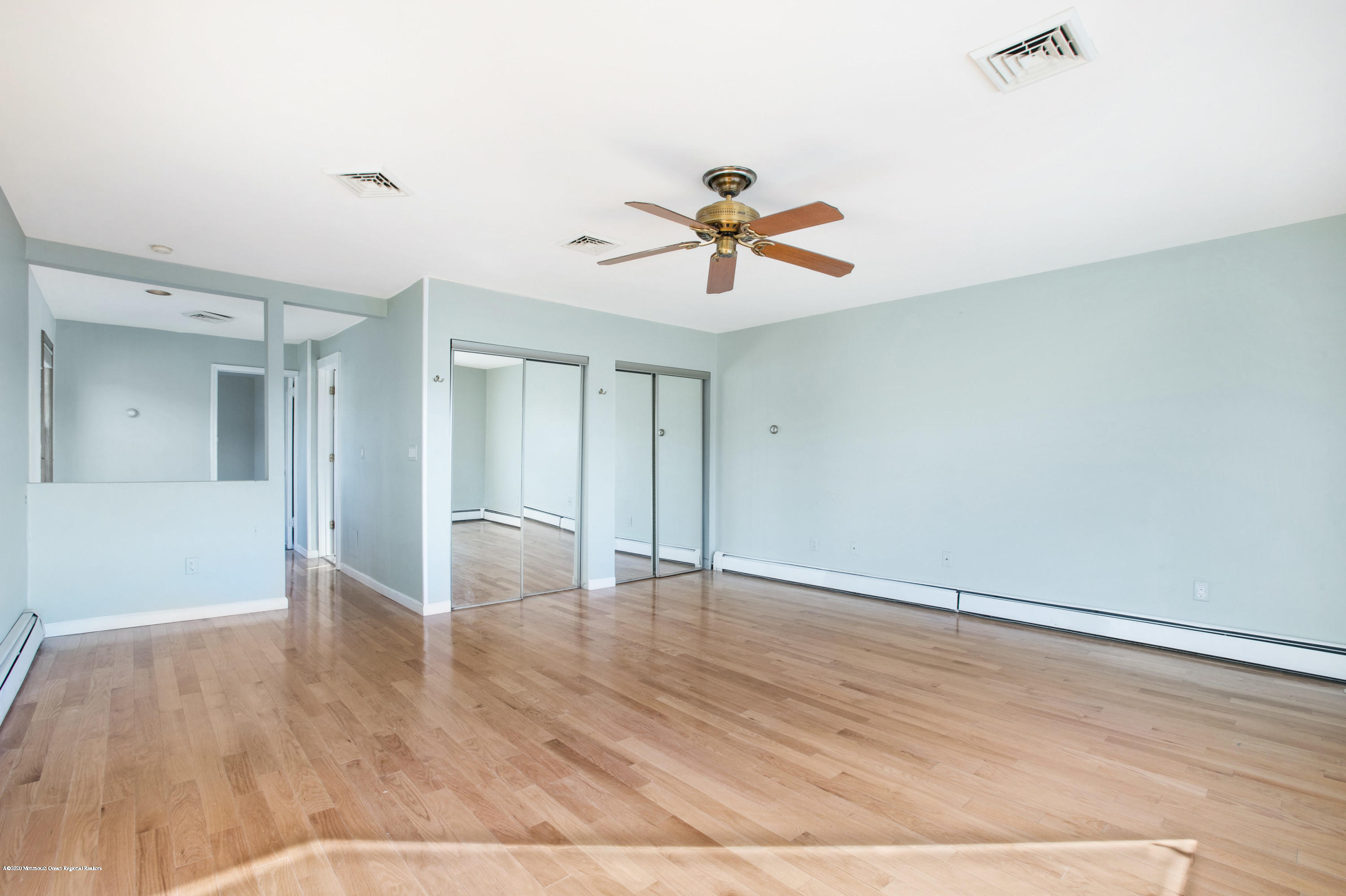 35 Boston Road Neptune City, NJ 07753 - Photo 25 of 30 a view of an empty room with window and wooden floor
