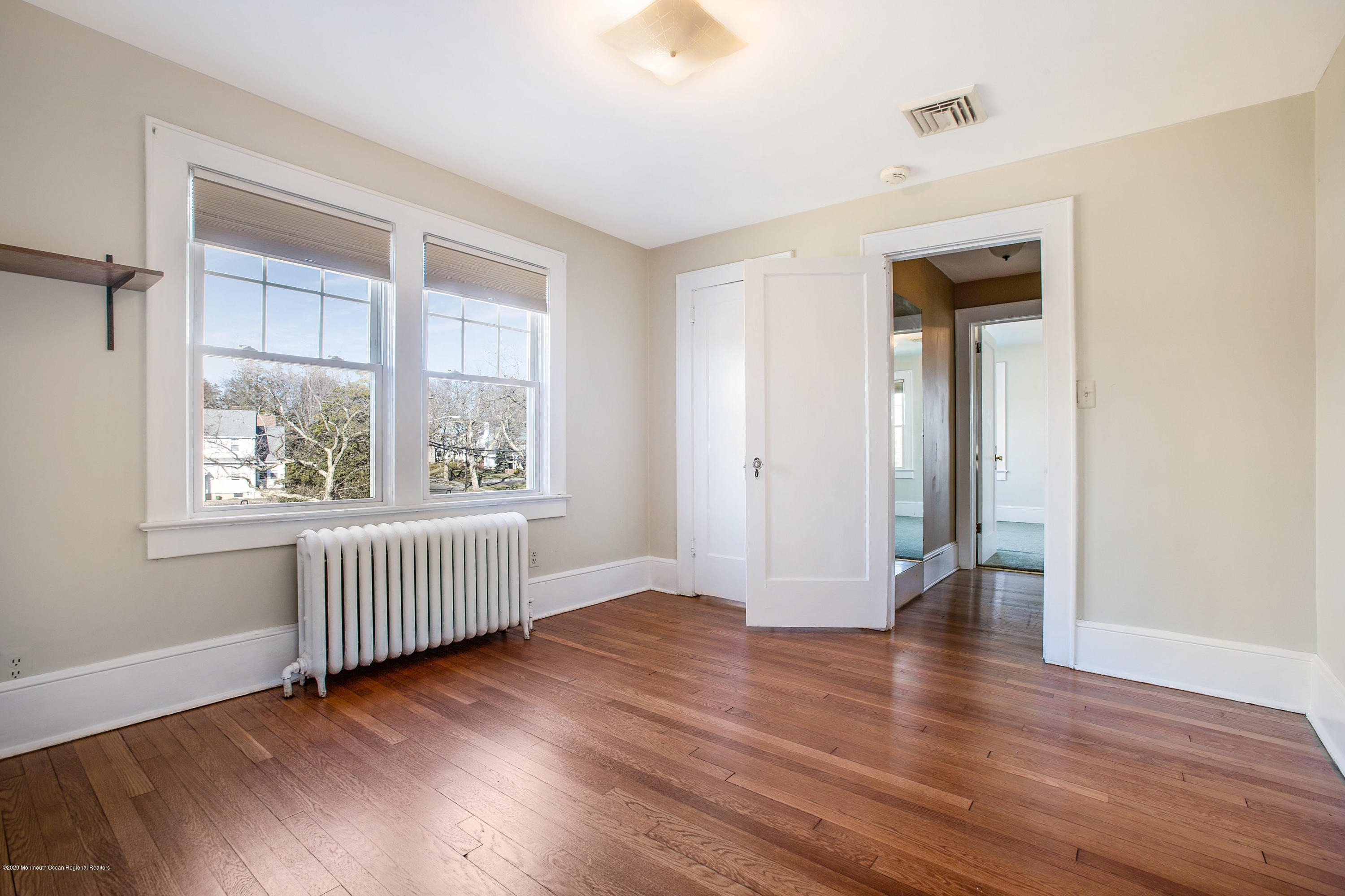 35 Boston Road Neptune City, NJ 07753 - Photo 29 of 30 an empty room with wooden floor and windows