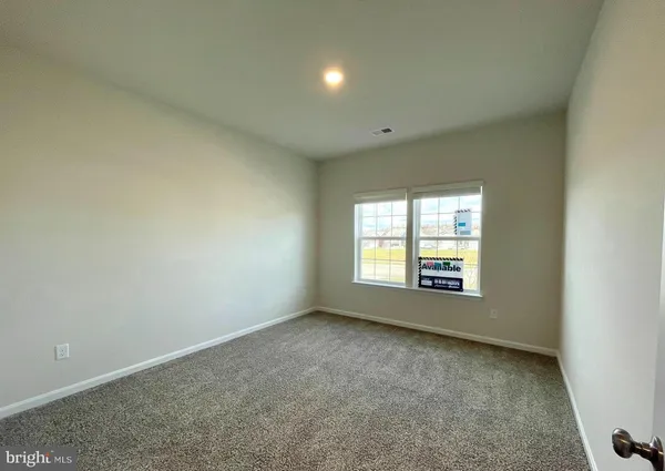 an empty room with a empty space and windows