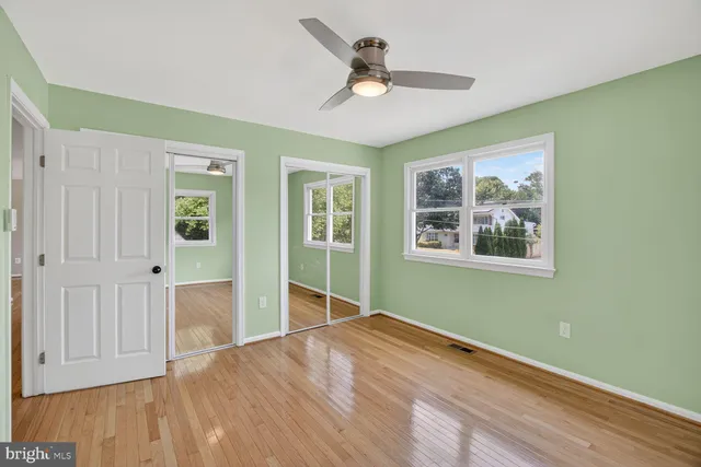 a view of empty room with wooden floor