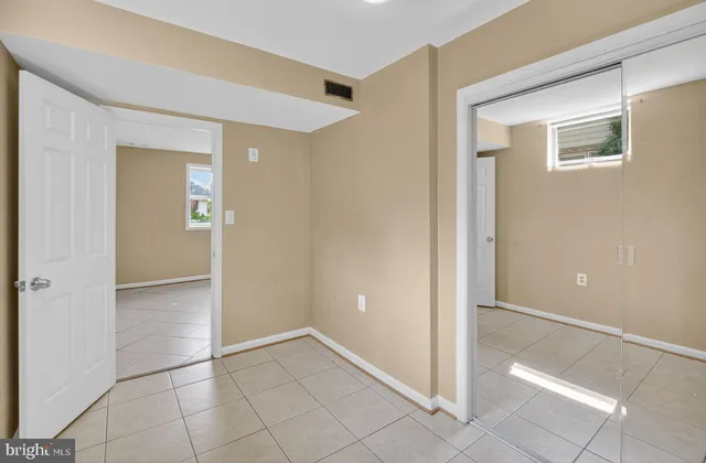 a view of a hallway with wooden floor and closet