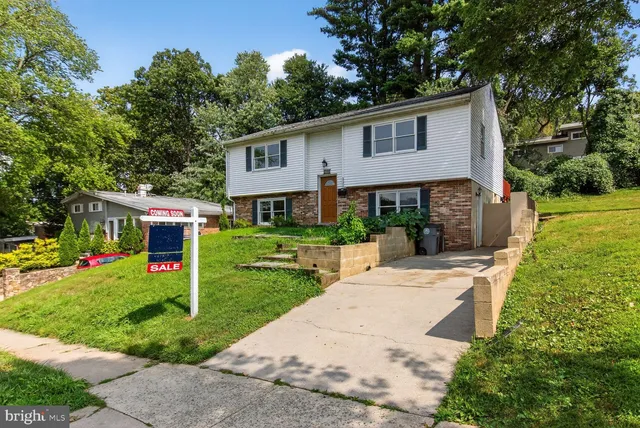 a view of a house with a yard and potted plants
