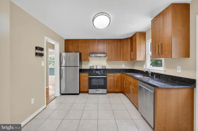 a kitchen with a refrigerator sink and cabinets