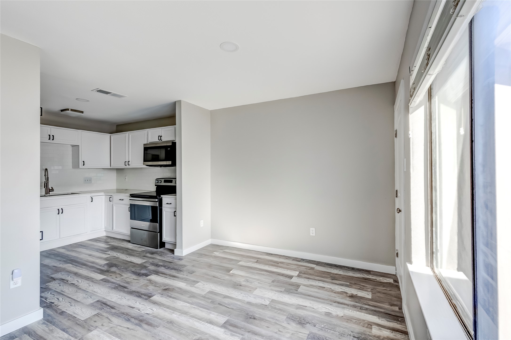 1740 Timber Ridge Road, Unit 136 Austin, TX 78741 - Photo 11 of 32 a view of a kitchen with a sink and dishwasher a stove top oven