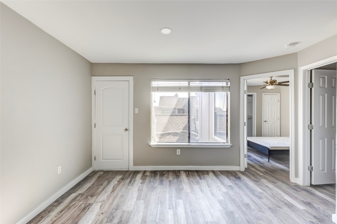1740 Timber Ridge Road, Unit 136 Austin, TX 78741 - Photo 16 of 32 Empty room featuring light wood finished floors and a ceiling fan