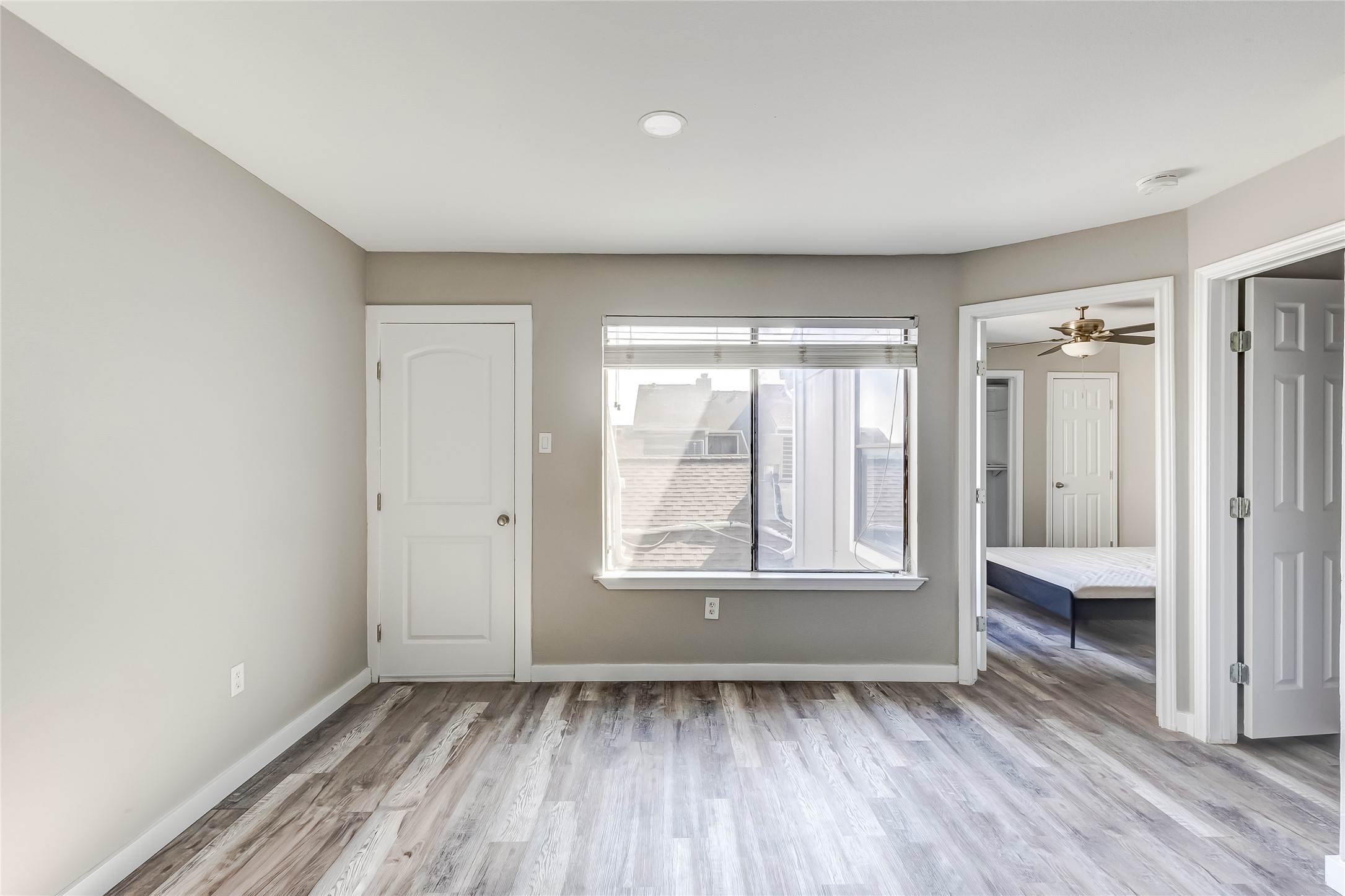 1740 Timber Ridge Road, Unit 136 Austin, TX 78741 - Photo 16 of 32 a view of an empty room with wooden floor and a window