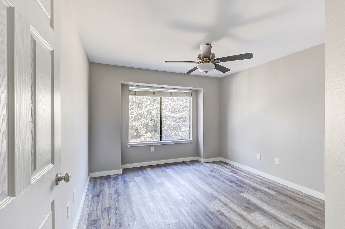 1740 Timber Ridge Road, Unit 136 Austin, TX 78741 - Photo 18 of 32 Unfurnished room with light wood-style flooring and ceiling fan