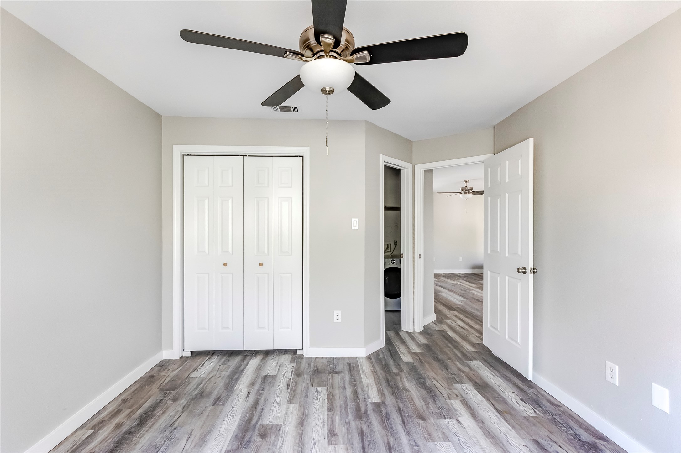 1740 Timber Ridge Road, Unit 136 Austin, TX 78741 - Photo 19 of 32 wooden floor in an empty room with a window