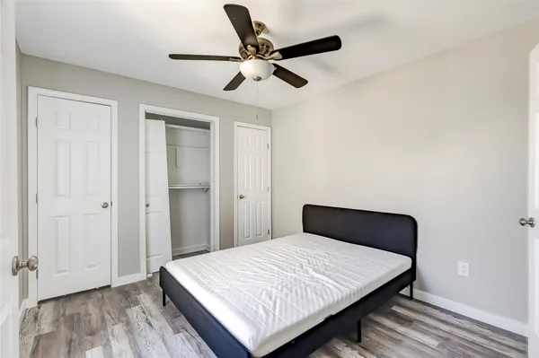 a bedroom with a large bed and a chandelier