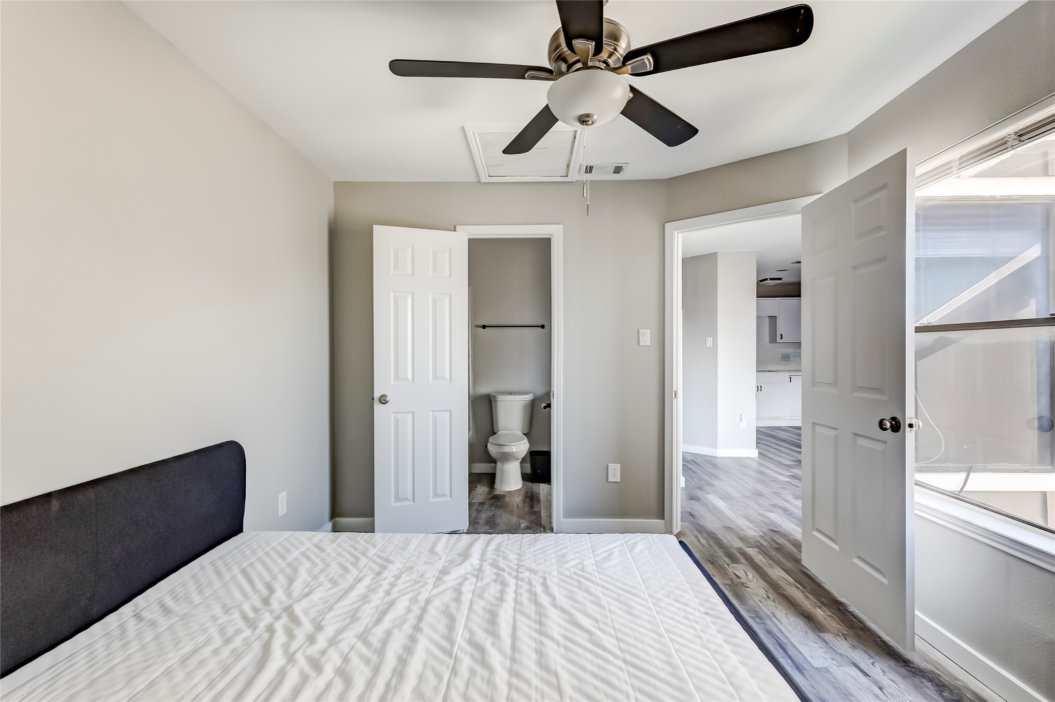 1740 Timber Ridge Road, Unit 136 Austin, TX 78741 - Photo 23 of 32 a bedroom with a large bed and a chandelier