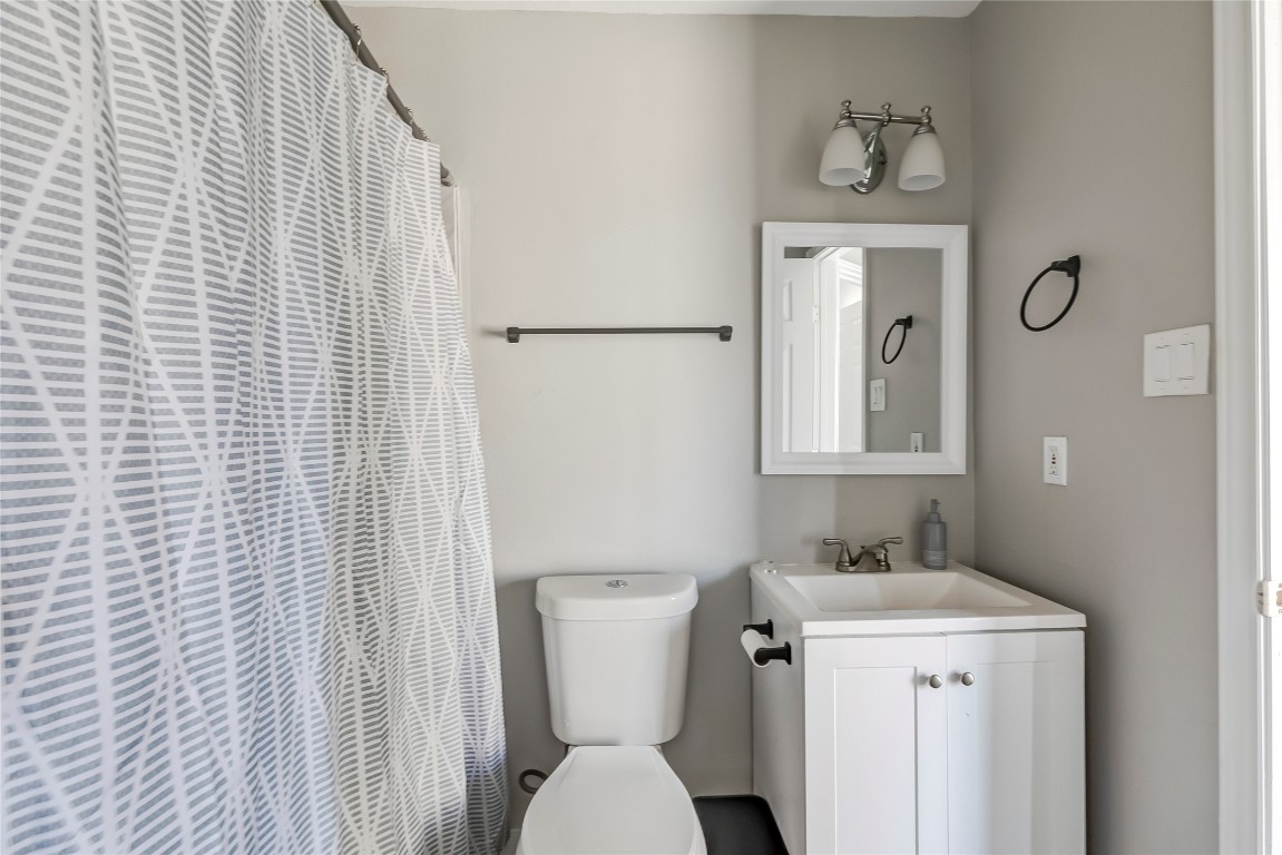 1740 Timber Ridge Road, Unit 136 Austin, TX 78741 - Photo 25 of 32 Bathroom with a shower with curtain and vanity