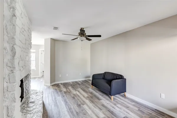 a living room with furniture and a ceiling fan