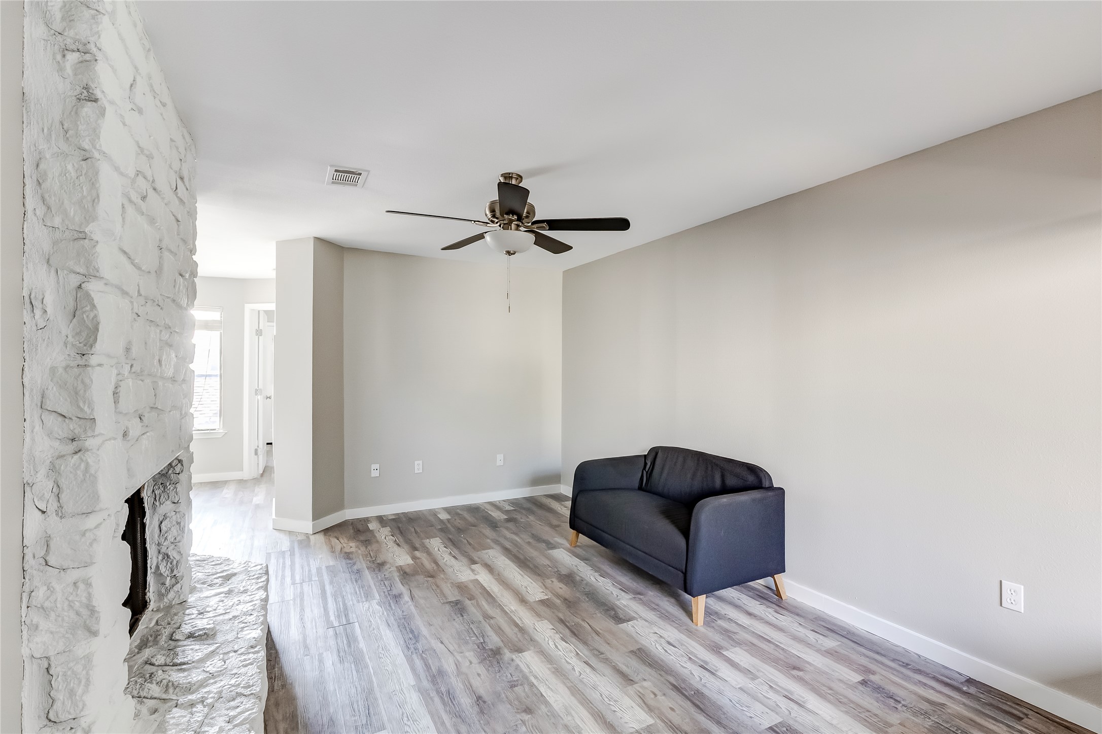 1740 Timber Ridge Road, Unit 136 Austin, TX 78741 - Photo 5 of 32 a living room with furniture and a ceiling fan