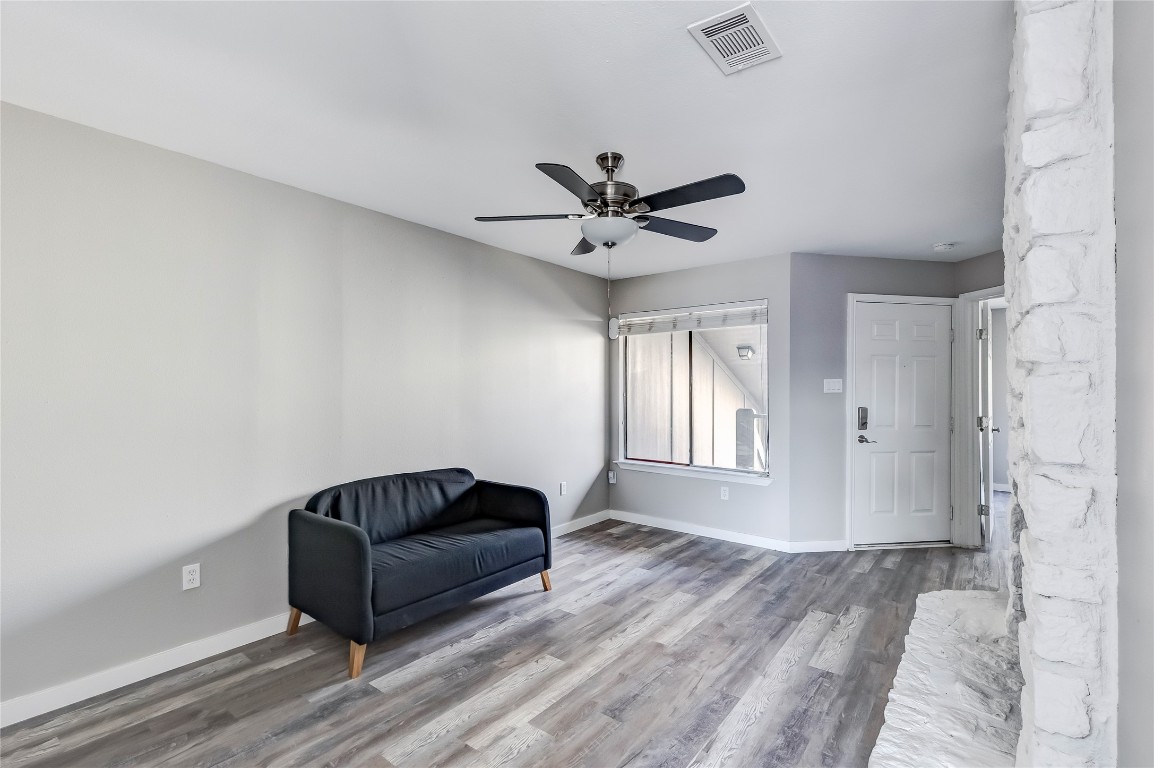 1740 Timber Ridge Road, Unit 136 Austin, TX 78741 - Photo 10 of 32 Sitting room featuring wood finished floors and a ceiling fan