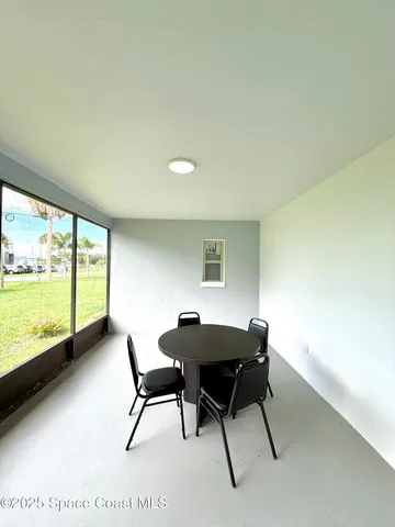 a workspace with furniture and a large window