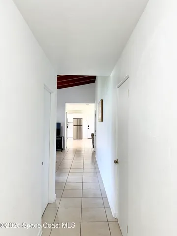 a view of a hallway with a white walls