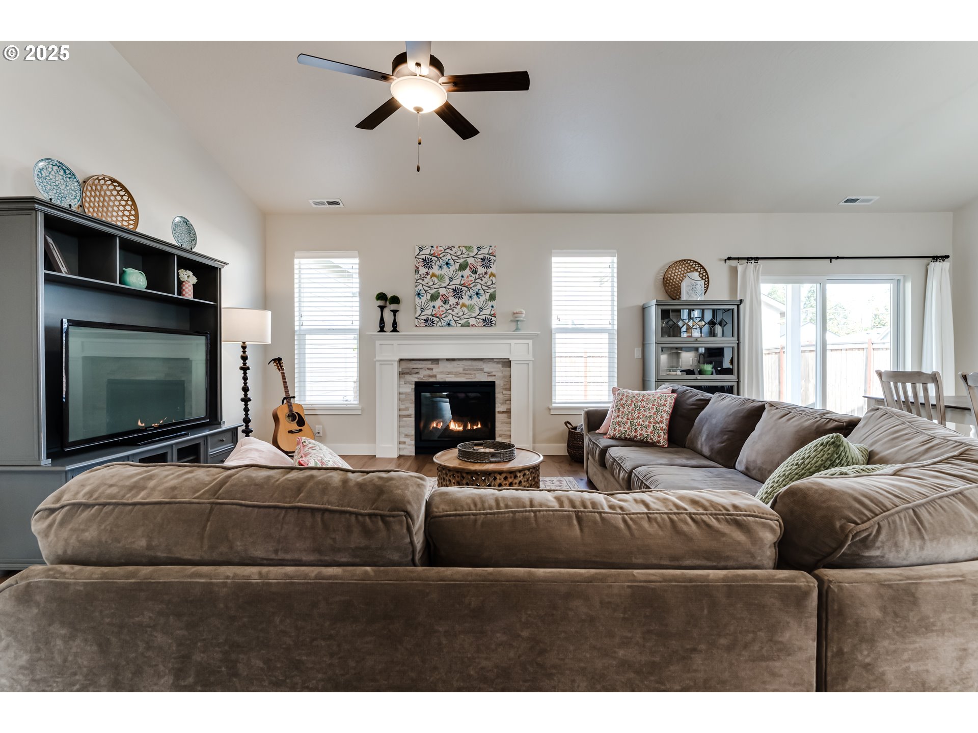3266 Mountain Crk Lane Springfield, OR 97478 - Photo 8 of 42 a living room with furniture a flat screen tv and a fireplace