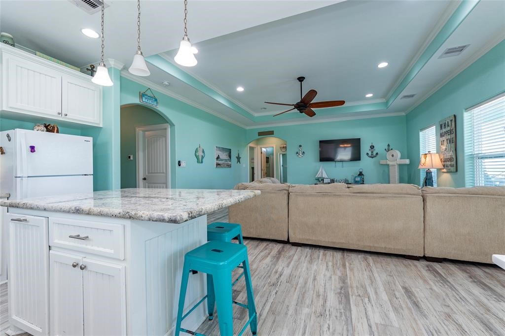 987 Surf Crystal Beach Crystal Beach, TX 77650 - Photo 14 of 45 a living room with kitchen island granite countertop furniture and a fireplace