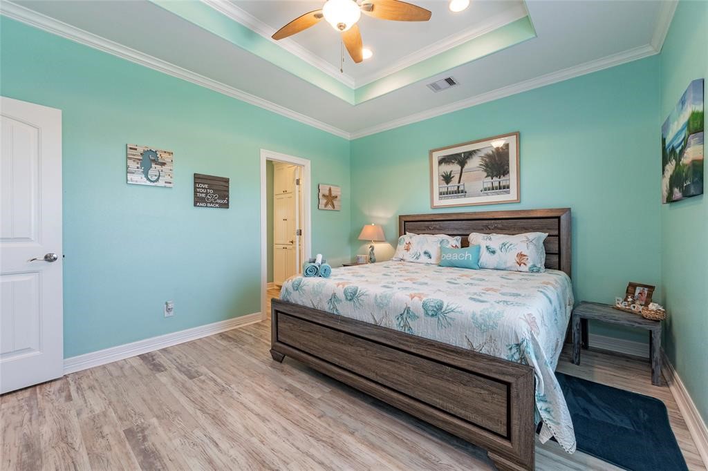 987 Surf Crystal Beach Crystal Beach, TX 77650 - Photo 21 of 45 a bedroom with a bed and a wall painting