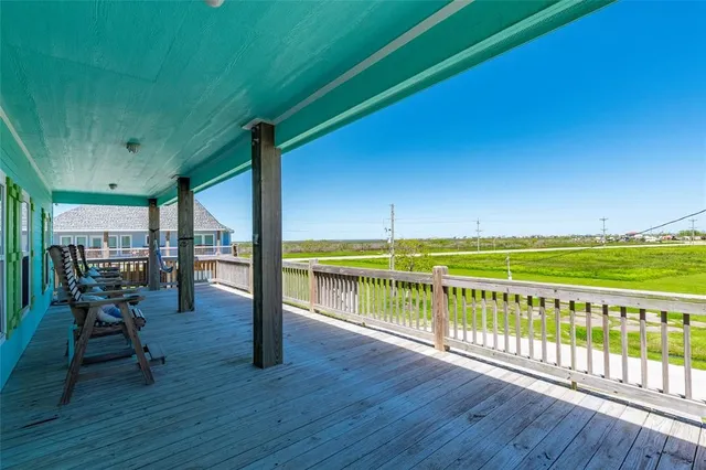 a view of a chairs and table on the wooden deck