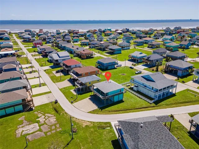 a aerial view of multiple houses with yard