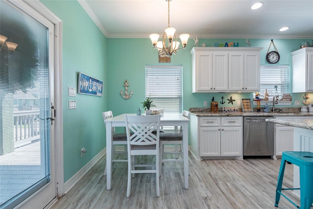 987 Surf Crystal Beach Crystal Beach, TX 77650 - Photo 10 of 45 a kitchen with a table and chairs in it