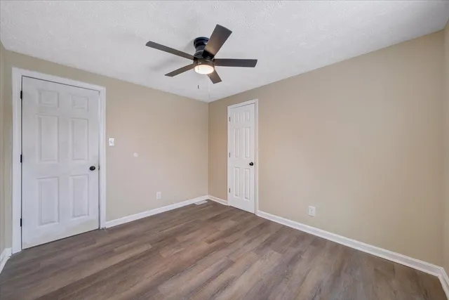 a view of a room with wooden floor and natural light