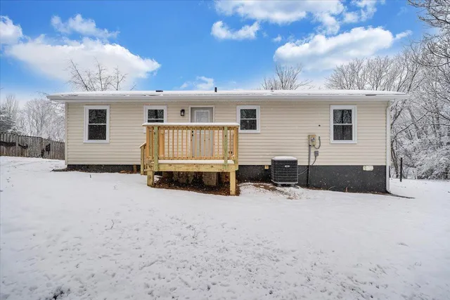 a view of a house with a snow in the yard
