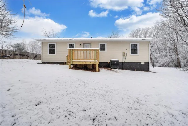 a view of a house with a snow in the yard