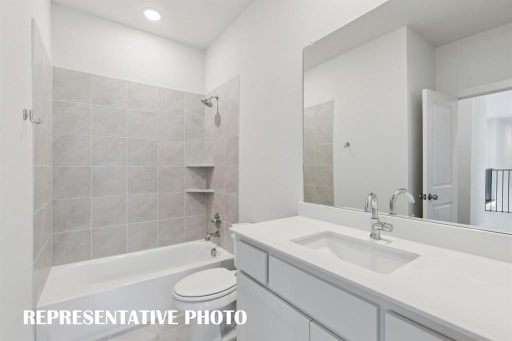 3909 Launch Road McKinney, TX 75071 - Photo 16 of 17 a bathroom with a sink a toilet and a bathtub
