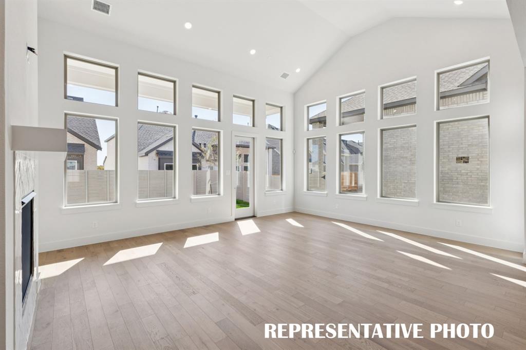 3909 Launch Road McKinney, TX 75071 - Photo 8 of 17 a view of an empty room with a window and wooden floor