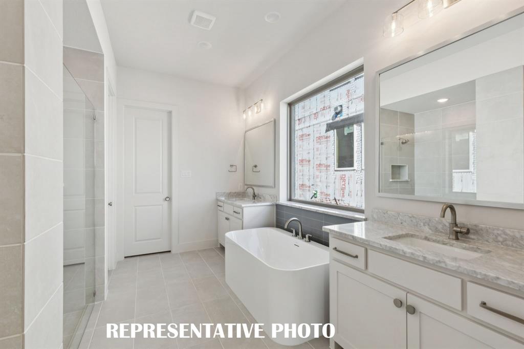 3909 Launch Road McKinney, TX 75071 - Photo 10 of 17 a spacious bathroom with a granite countertop sink and a mirror
