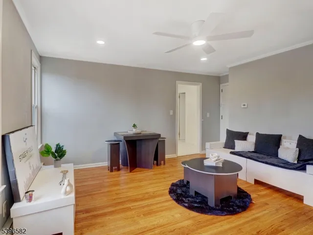 a living room with furniture a potted plant and a lamp