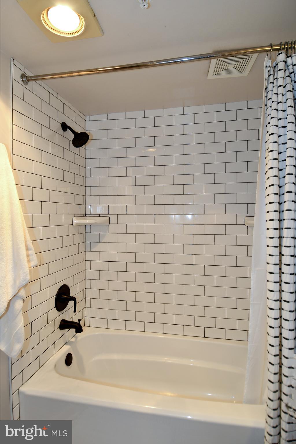 1731 Willard Street Northwest, Unit 105 Washington, DC 20009 - Photo 19 of 52 a bathroom with a bathtub and a shower