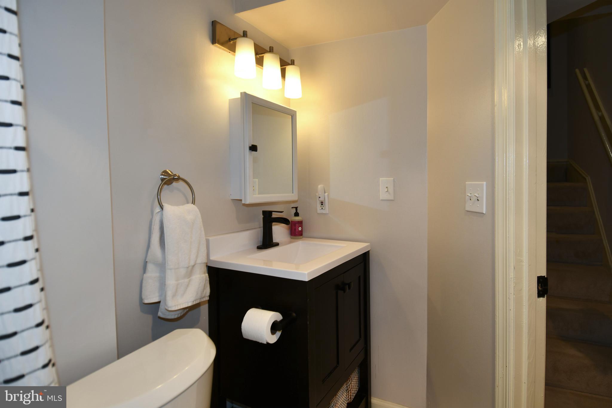 1731 Willard Street Northwest, Unit 105 Washington, DC 20009 - Photo 20 of 52 a bathroom with a sink toilet and mirror