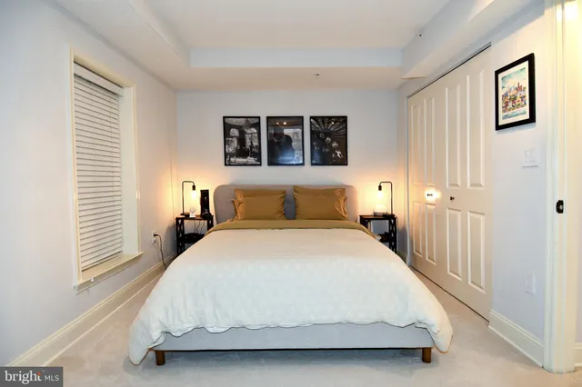 a bedroom with a bed and a night stand