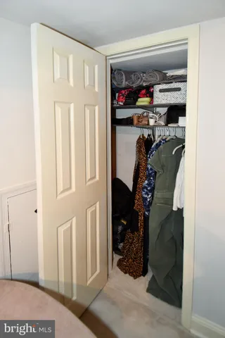 a view of a hallway with lots of frames on wall