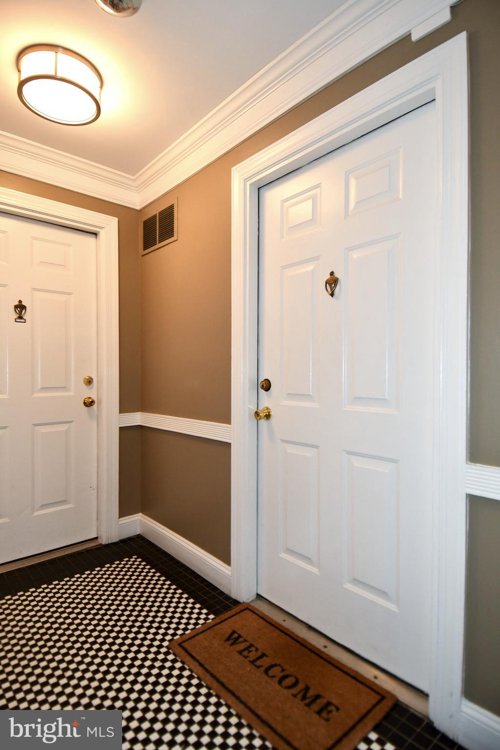 1731 Willard Street Northwest, Unit 105 Washington, DC 20009 - Photo 3 of 52 a view of a hallway with wooden floor and a bathroom
