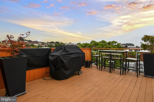 a terrace with outdoor seating and city view