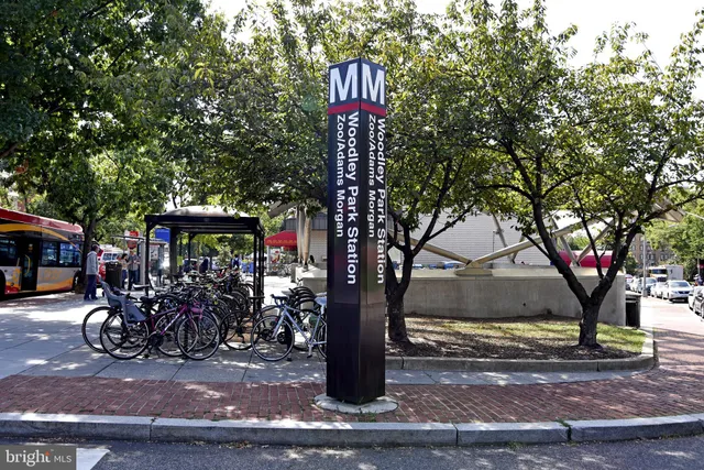 a front view of a multi story building with yard