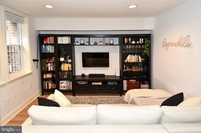 a living room with fireplace furniture and a flat screen tv