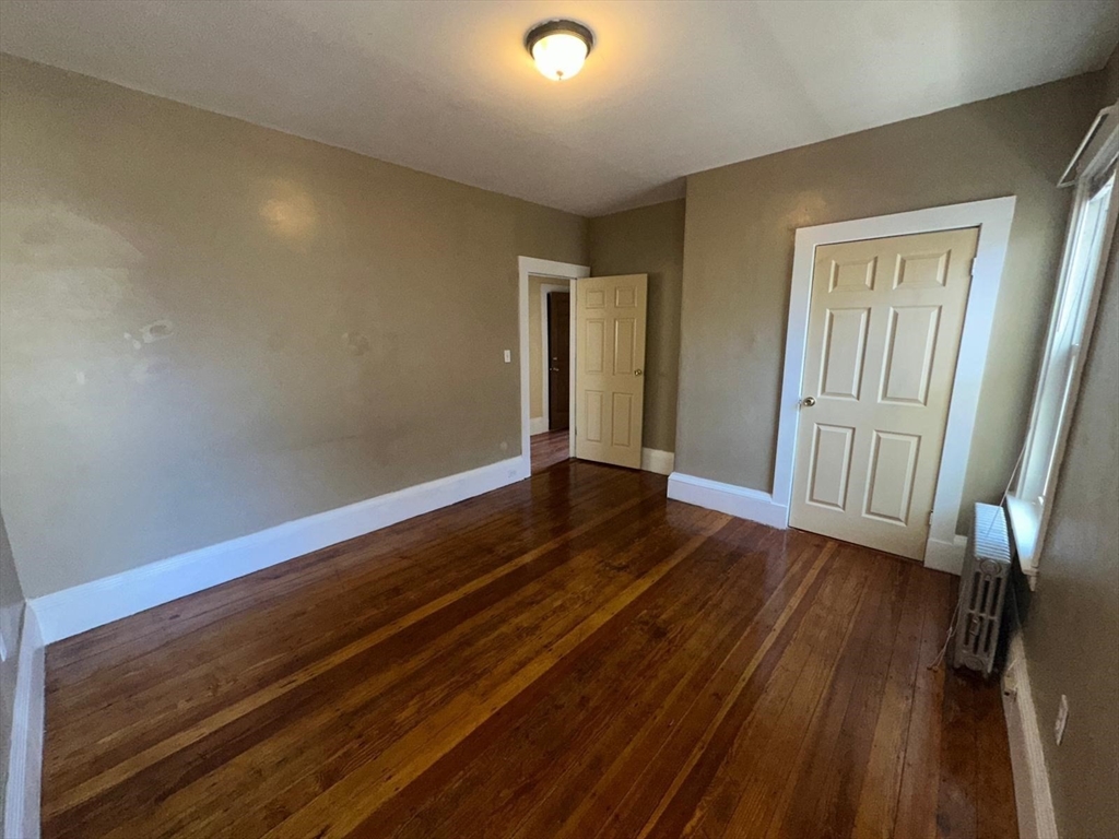 18 Hendry Street, Unit 2 Boston, MA 02122 - Photo 11 of 15 a view of an empty room and wooden floor