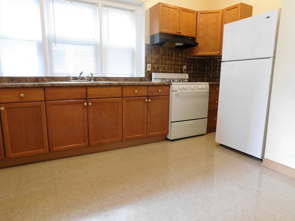 18 Hendry Street, Unit 2 Boston, MA 02122 - Photo 4 of 15 a kitchen with cabinets a refrigerator and a sink