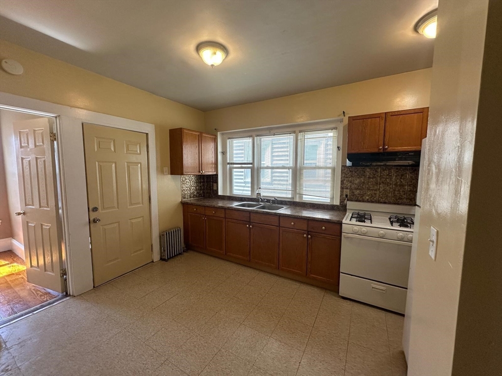 18 Hendry Street, Unit 2 Boston, MA 02122 - Photo 6 of 15 a kitchen with a refrigerator sink and stove