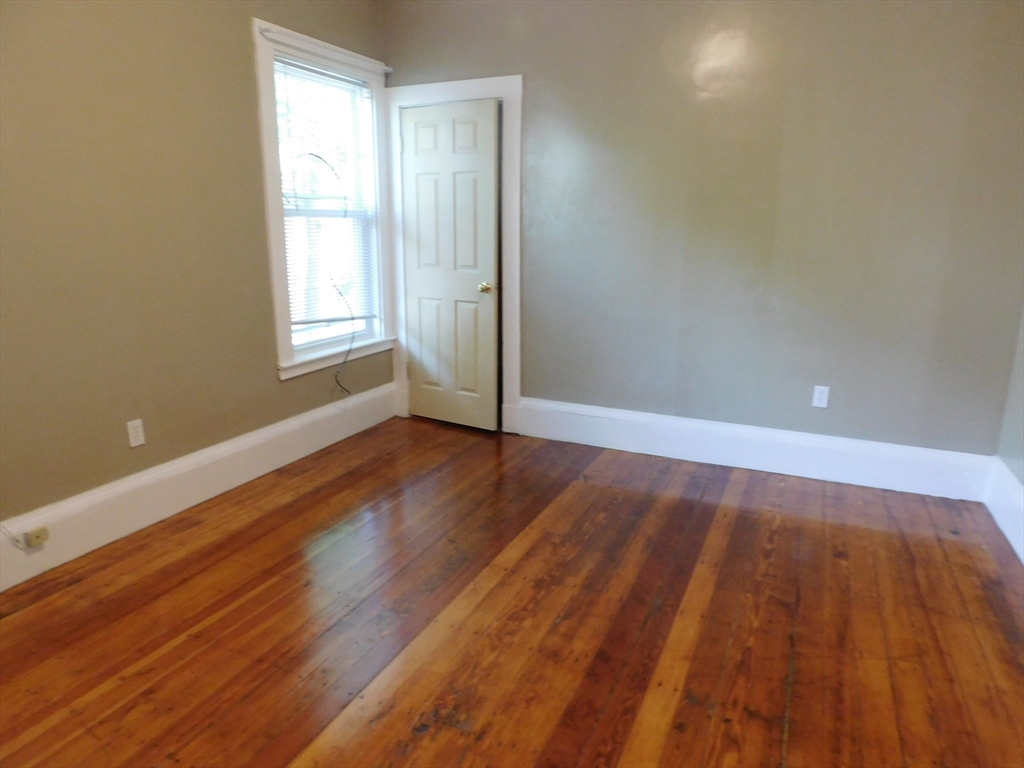 18 Hendry Street, Unit 2 Boston, MA 02122 - Photo 8 of 15 an empty room with wooden floor and windows