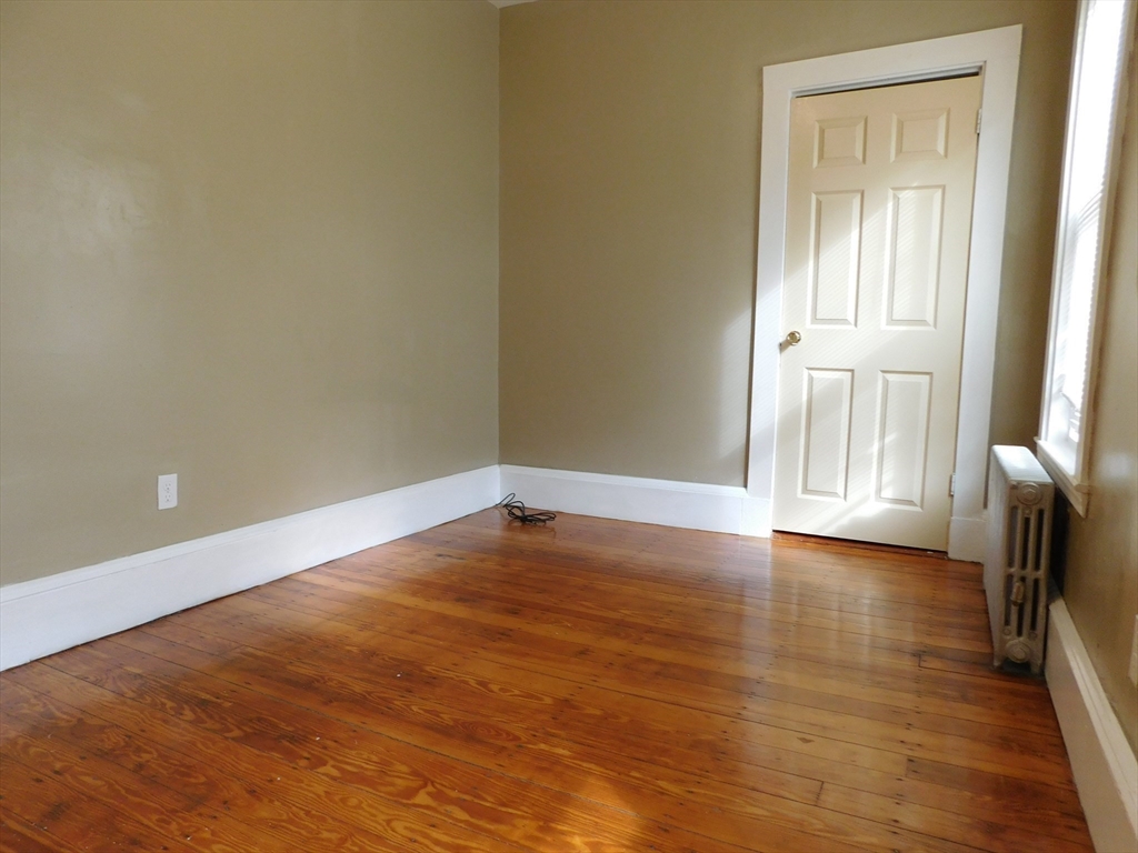 18 Hendry Street, Unit 2 Boston, MA 02122 - Photo 9 of 15 a view of an empty room with wooden floor and a window