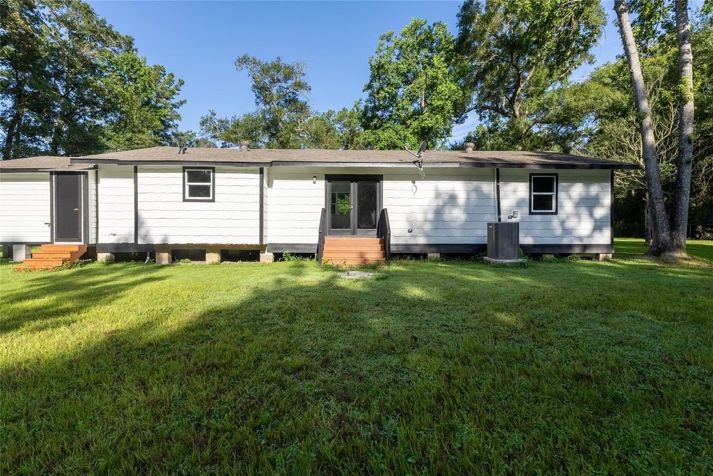 7728 White Rock Road Cleveland, TX 77328 - Photo 2 of 36 a house view with a sitting space and garden