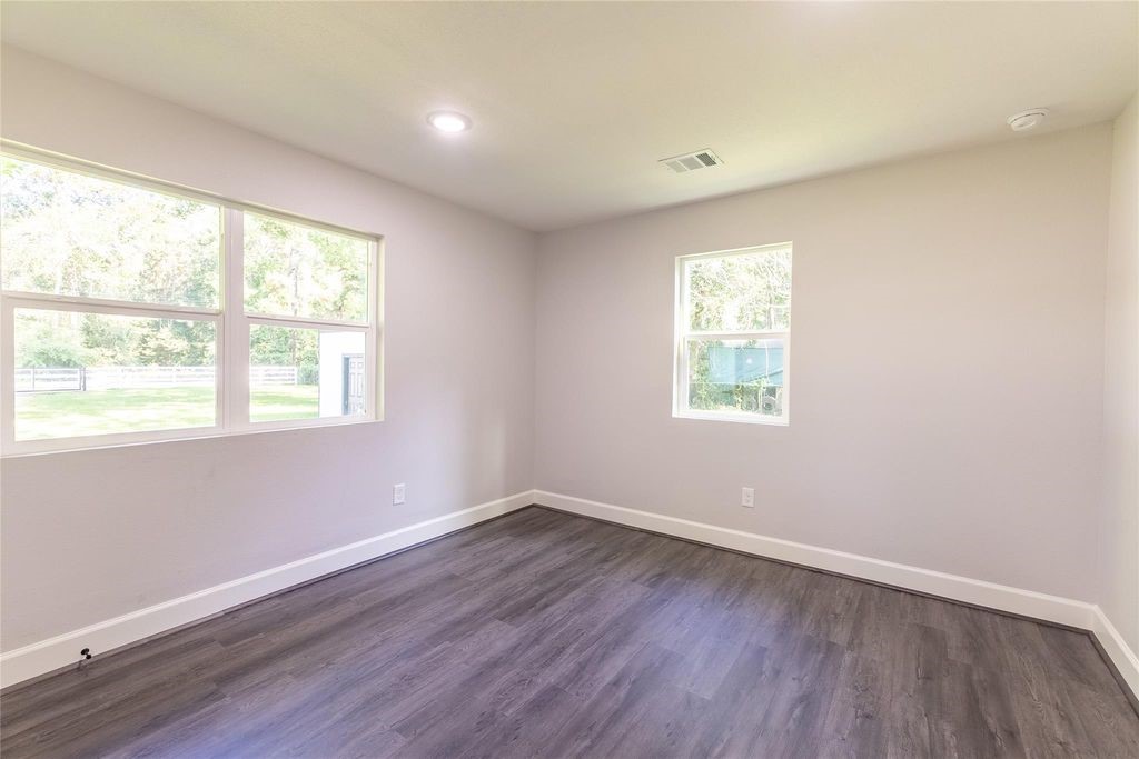 7728 White Rock Road Cleveland, TX 77328 - Photo 23 of 36 a view of a room with wooden floor and windows in it