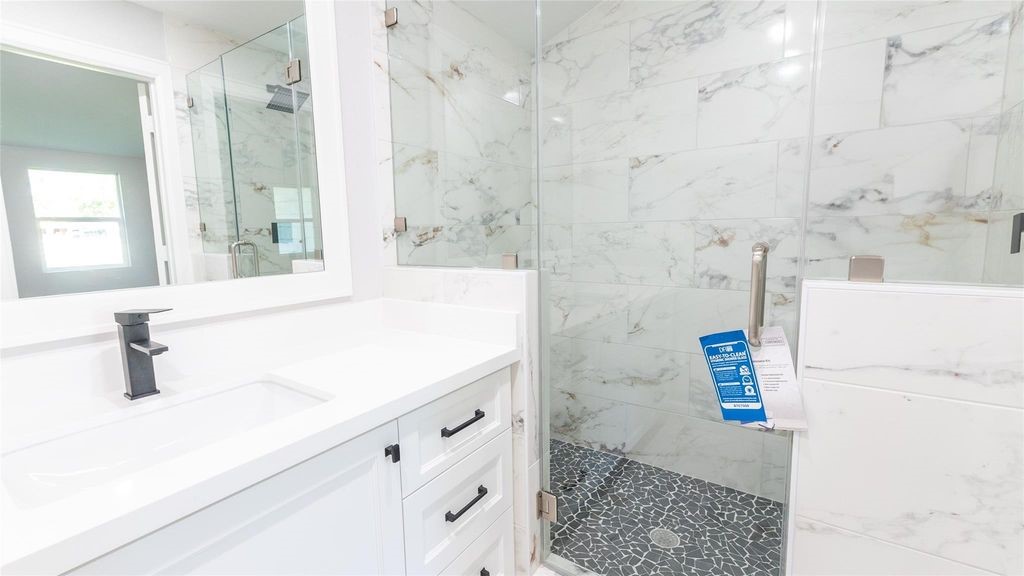 7728 White Rock Road Cleveland, TX 77328 - Photo 26 of 36 a bathroom with a sink and a mirror