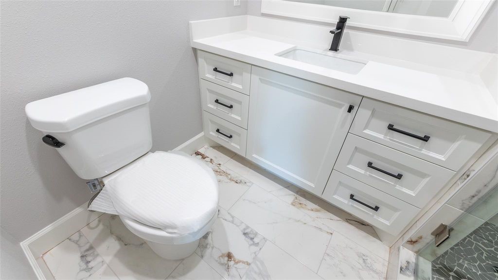 7728 White Rock Road Cleveland, TX 77328 - Photo 29 of 36 a white toilet sitting next to a sink